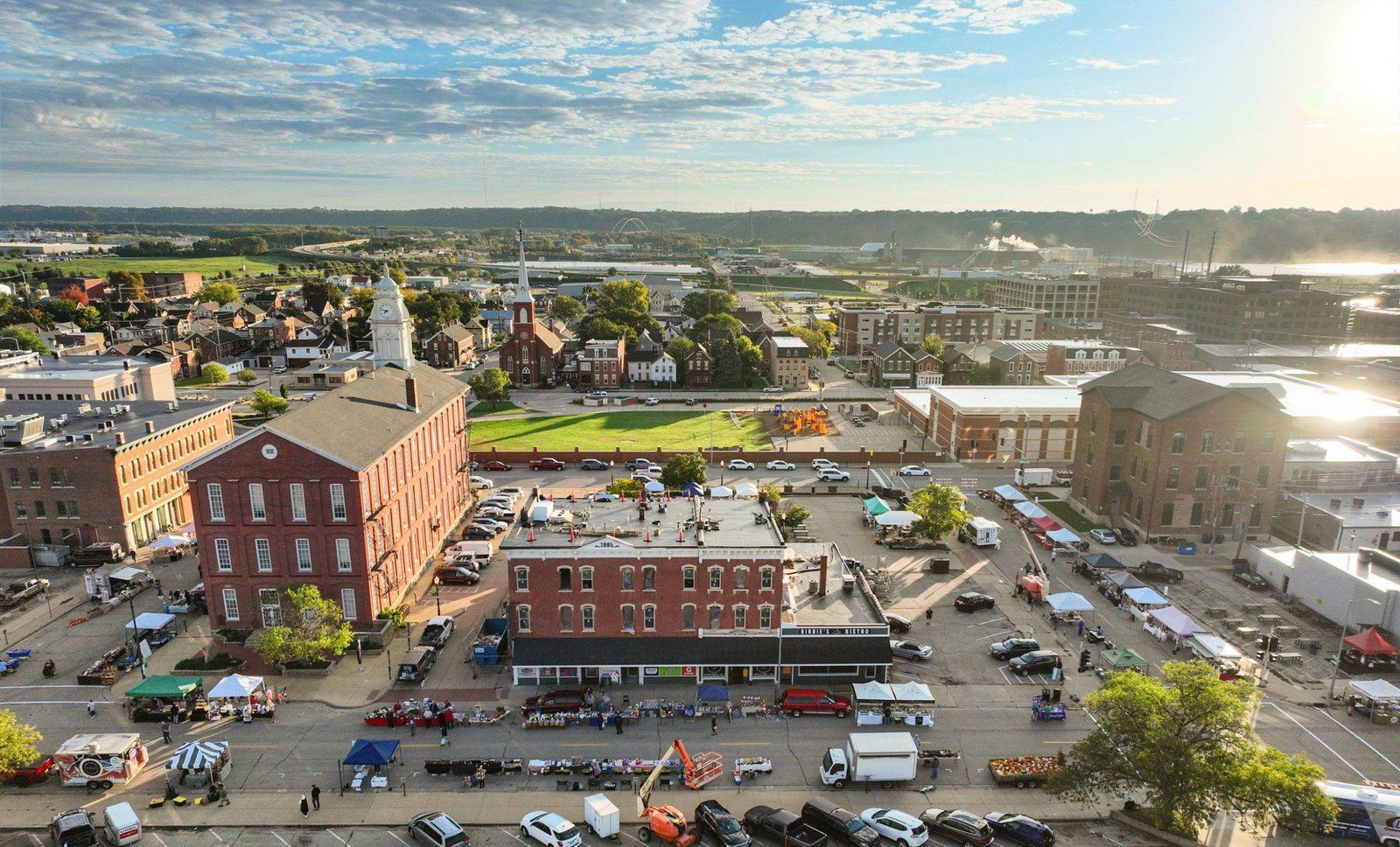 Aerial photo of the Iowa Street Lofts building at 1236-48 Iowa Street, mid-renovation, showing the 1885 datestone and the Birdie's Bistro storefront sign