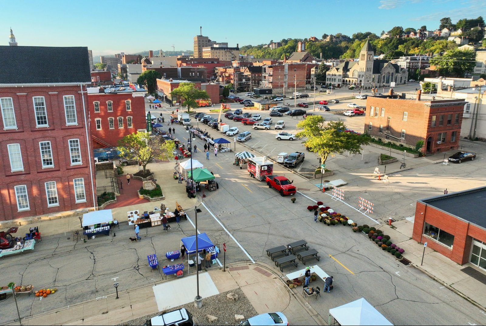 Aerial view of downtown Dubuque during the Farmers' Market, looking down Iowa Street past City Hall toward the surrounding bluffs